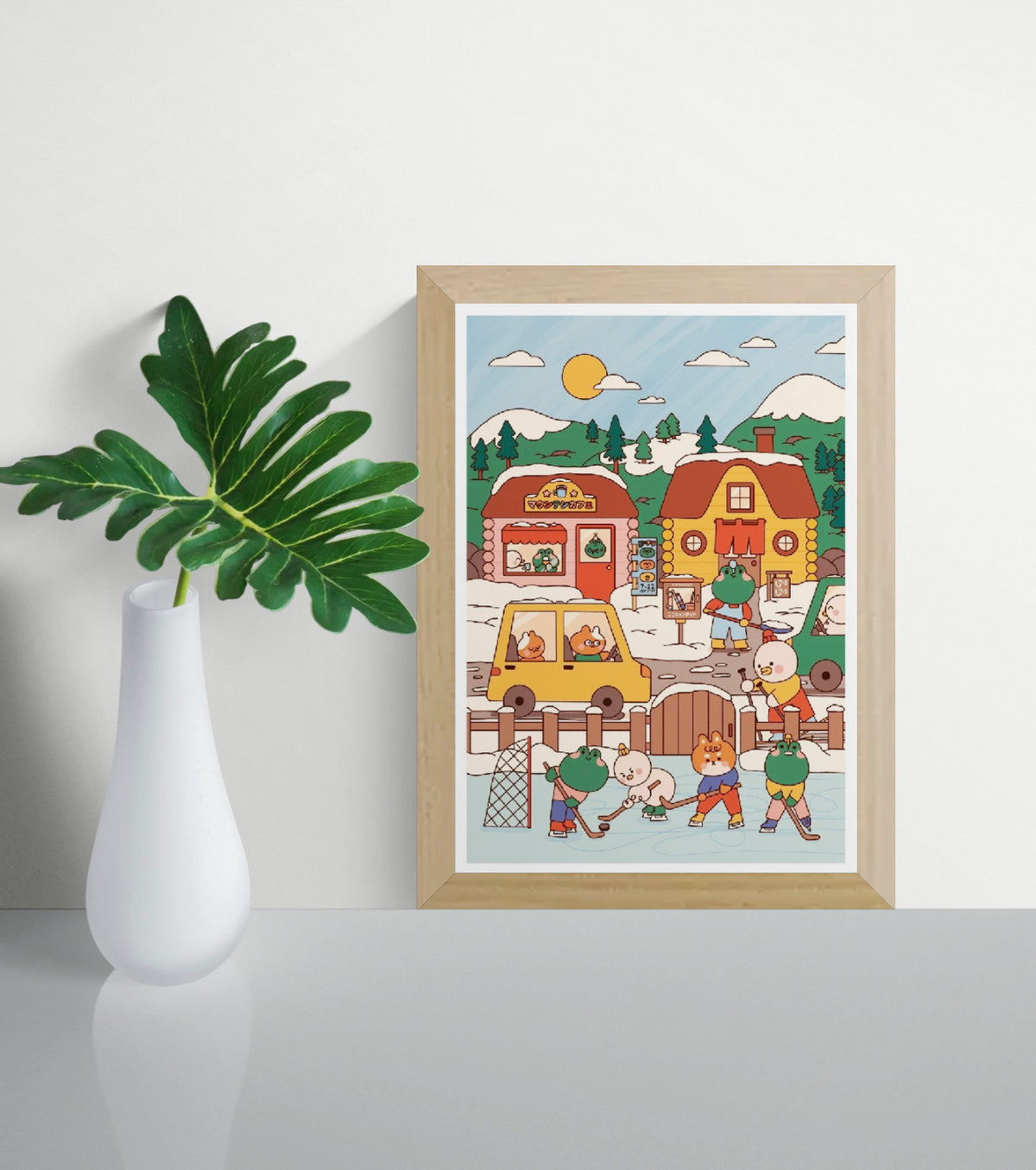 Mountain Village by Niniwanted, a colorful vertical digital art print of cute animal characters playing ice hockey in a snowy Japanese-inspired village, with cozy cabins, pine trees, and mountains.