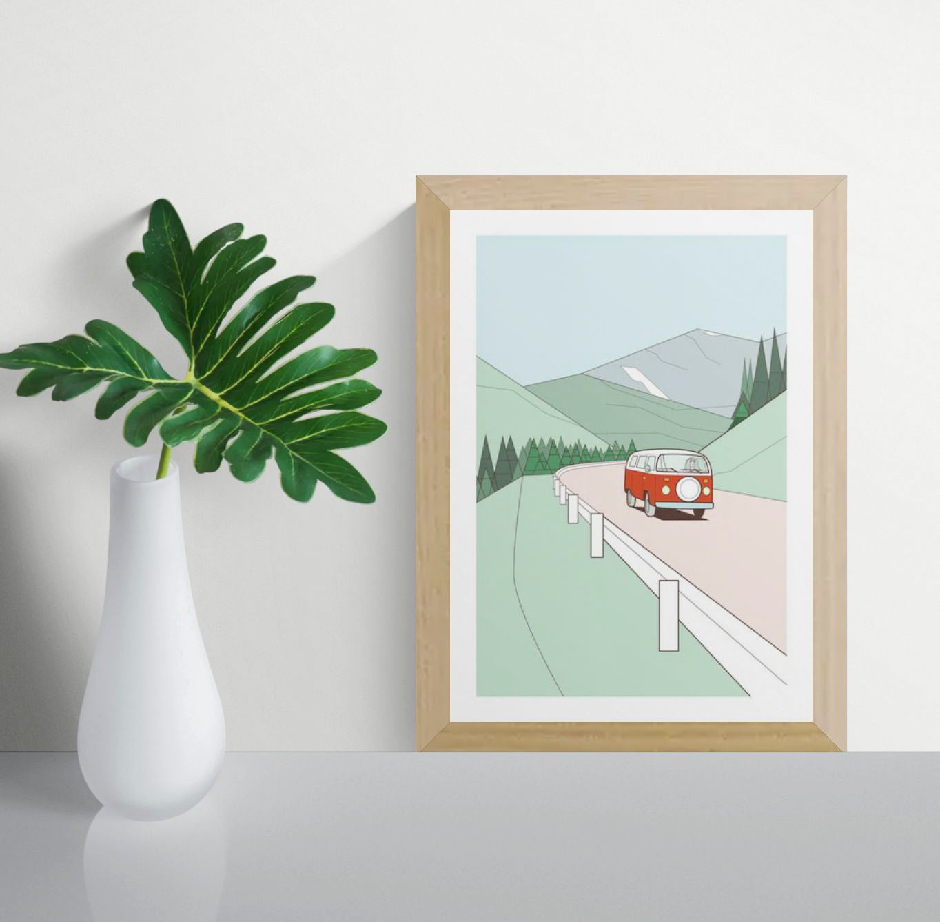 Minimalist art print of a red vintage van driving through green hills with pine trees and mountains in the background – travel-themed illustration by Floor 4 Productions