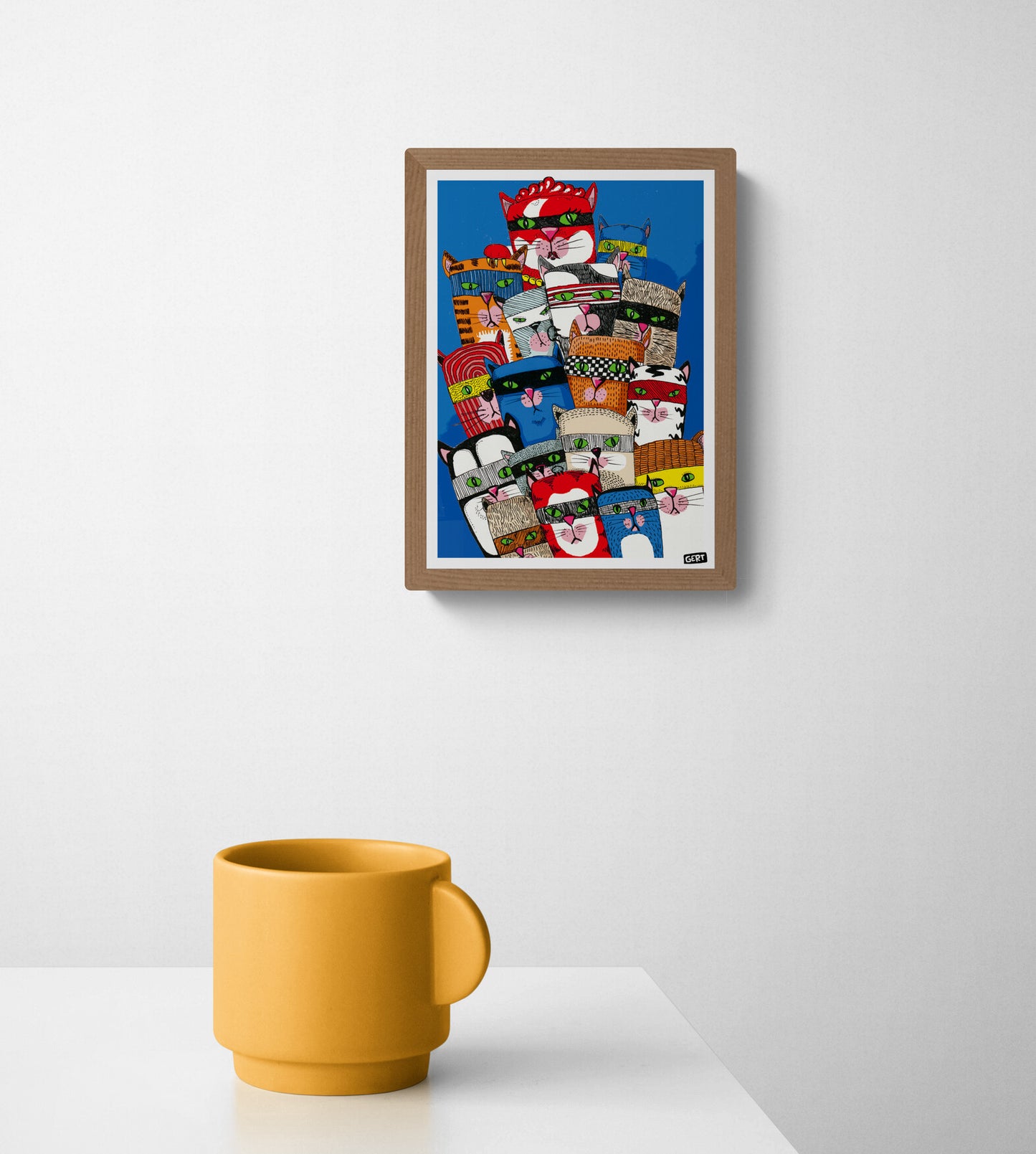 Colorful Cat Gang digital art print by Belgian illustrator Gert Paenen featuring a group of playful masked cats with bright green eyes against a deep blue background, contemporary graphic wall art for modern interiors.