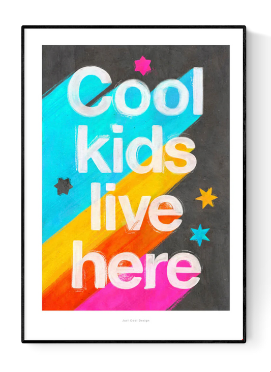 Giclée art print by Just Cool Design with the phrase "Cool kids live here" in bold white letters over a bright rainbow background with stars, ideal for colorful children's rooms or playful modern decor.