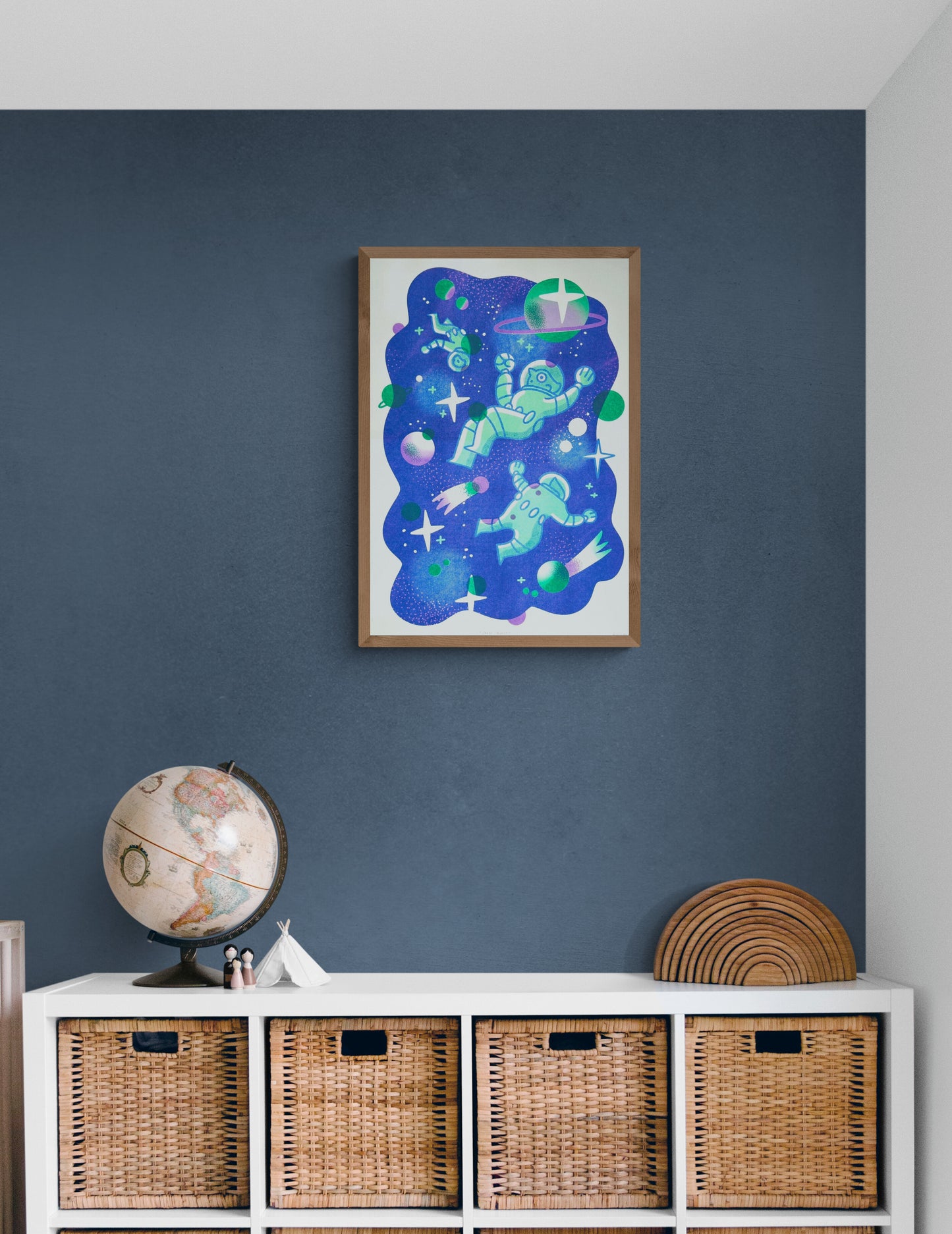 A3 limited edition risograph art print titled Space Quest by Belgian illustrator Auwnanas, featuring playful green astronauts floating in deep blue outer space with planets, stars, and graphic cosmic elements, contemporary wall art made in Belgium.