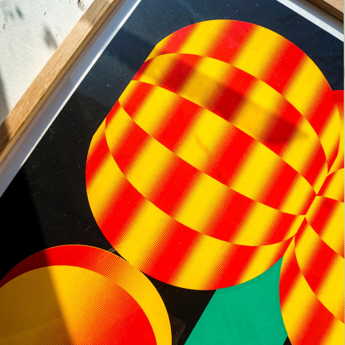 Bold graphic screenprint of a stylized red and yellow flower with geometric shapes on a black background – popping flower by PTRVRKD, 40 x 50 cm limited edition art print made in the Netherlands.