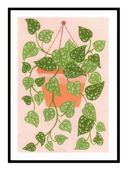 Scindapsus plant art print by Leens with cascading green leaves in a hanging terracotta pot on a blush pink background, modern botanical wall decor for cozy interiors.