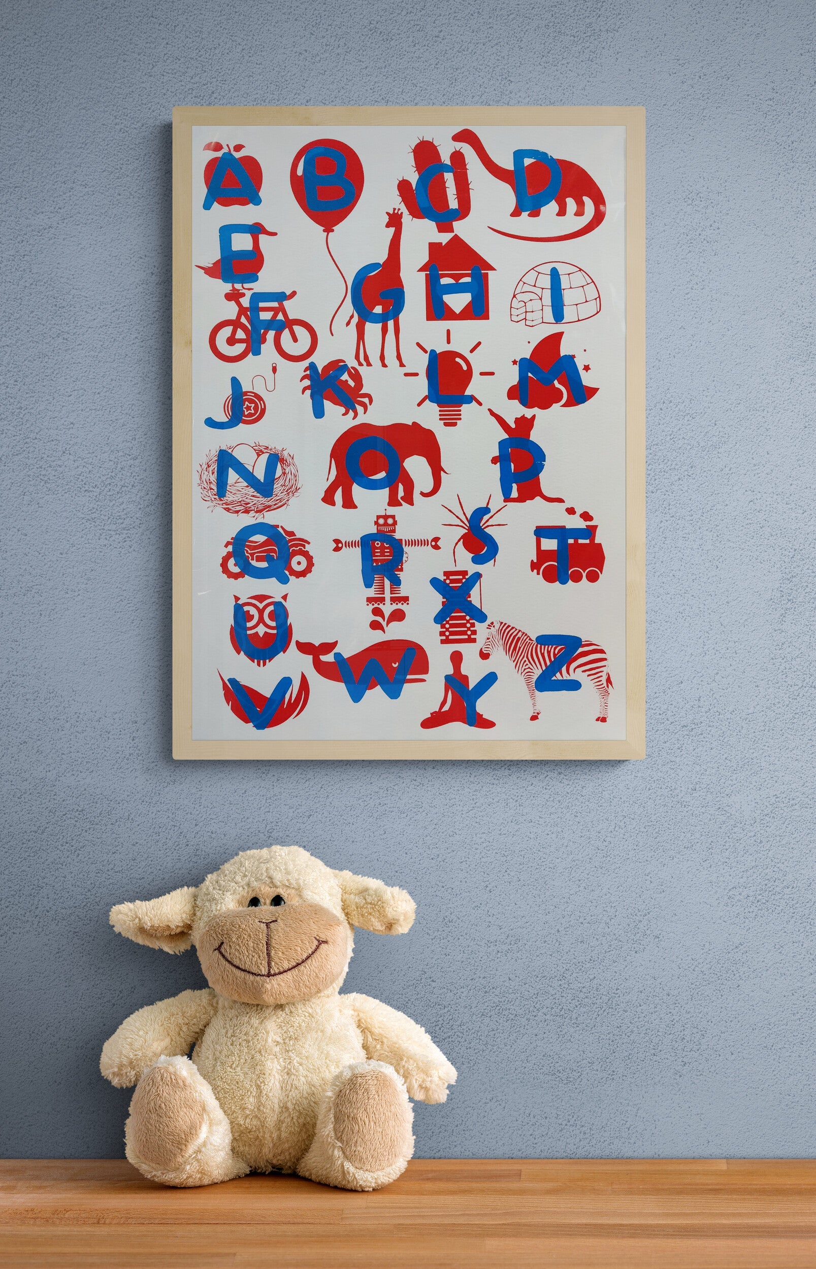 Playful and educational alphabet poster by De Zeverij featuring bold letters paired with charming red-blue or blue-yellow illustrations of animals, objects, and everyday items. Designed in a fun, screen-printed style perfect for children's rooms, classrooms, or creative spaces—an eye-catching blend of learning and modern design